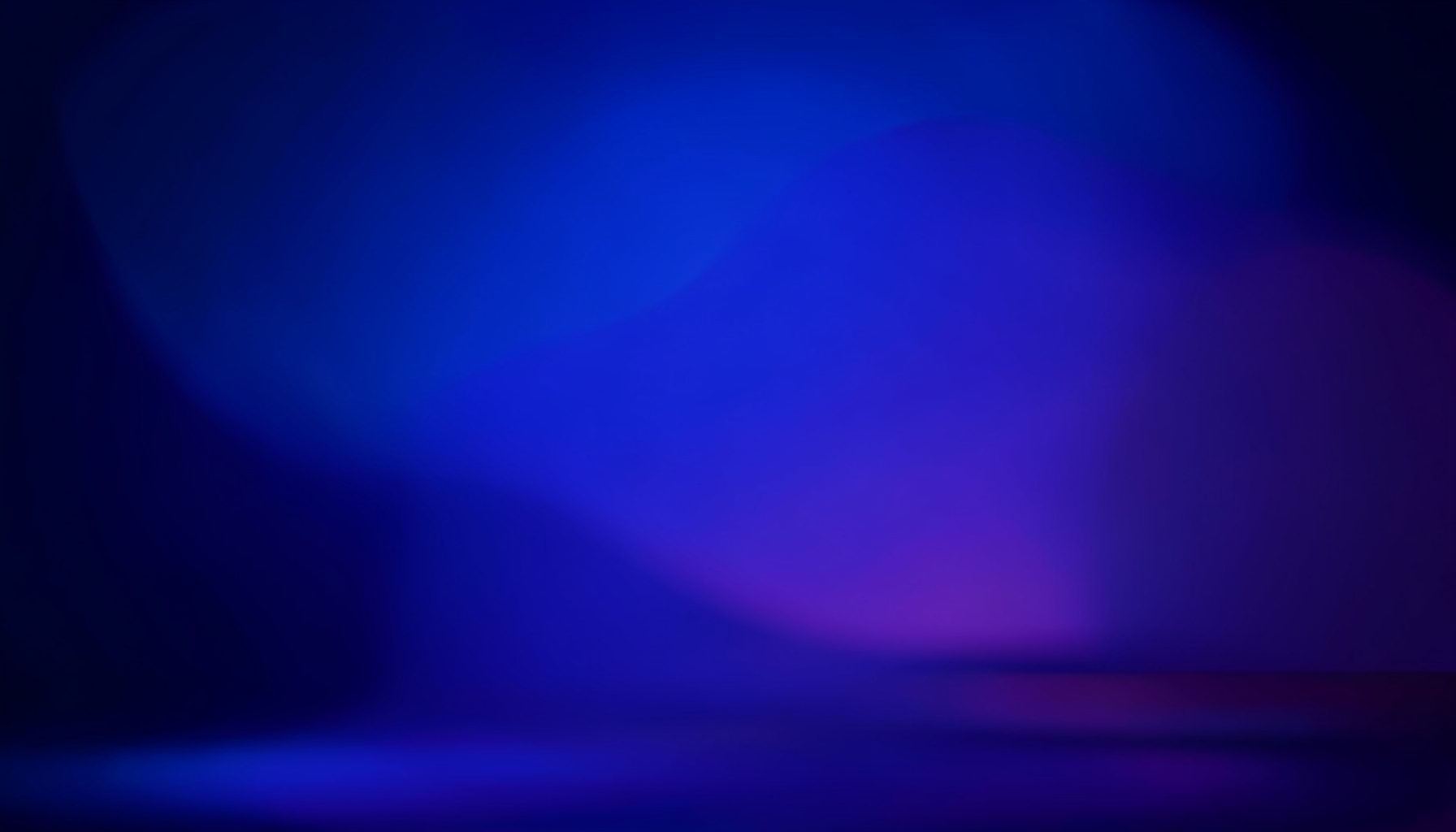 Wide stage view with deep blue and purple ambient lighting